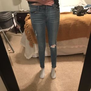 Versace distressed skinny jeans with ankle zip.